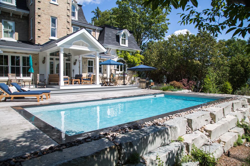 rectangular pool with concrete and granite deck